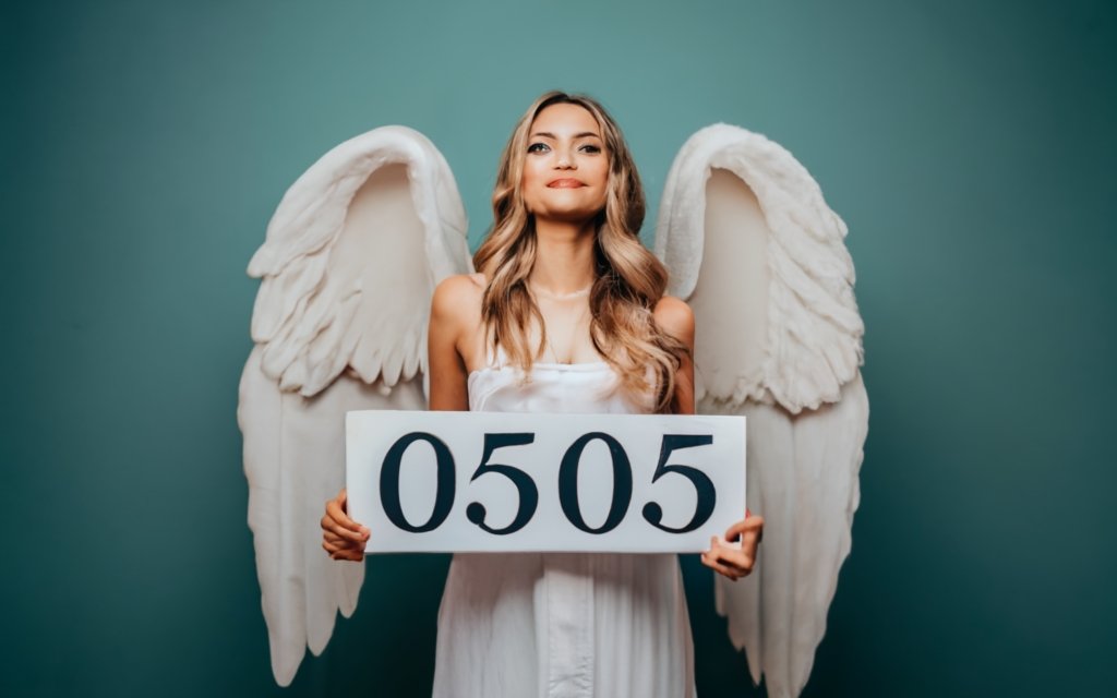 an angel holding a sign with text 0505