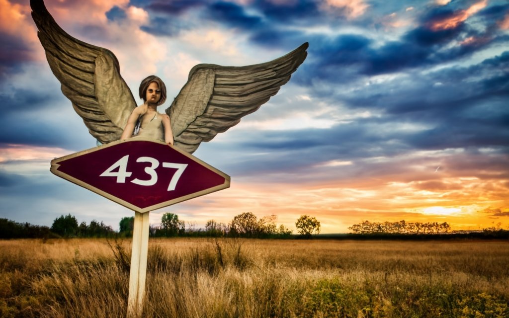 an angel flying standing on a sign with text 437